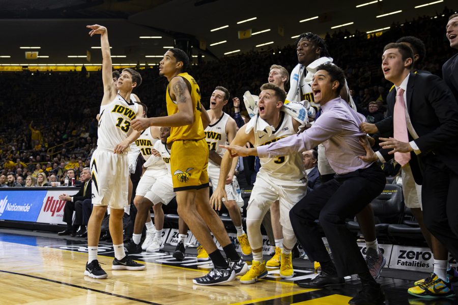 The Iowa bench watches a three point attempt by guard Austin Ash during Iowas game against Alabama State at Carver-Hawkeye Arena in Iowa City on Wednesday, November 21, 2018. The Hawkeyes defeated the Hornets 105-78