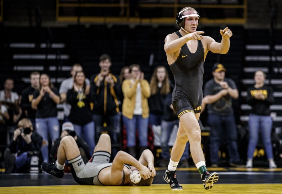 Iowa's Kaleb Young points towards Iowa's bench after pinning Purdue's Griffin Parriott in 3:22 during Iowa's dual meet against Purdue at Carver-Hawkeye Arena in Iowa City on Saturday, November 24, 2018. The Hawkeyes defeated Boilermakers, 26-9.