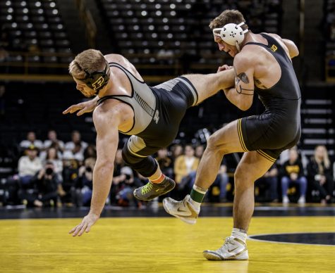 Iowas Cash Wilcke takes down Purdues Max Lyon during Iowas dual meet against Purdue at Carver-Hawkeye Arena in Iowa City on Saturday, November 24, 2018. Wilcke defeated Lyon 12-4 in a major decision. The Hawkeyes defeated Boilermakers 26-9.