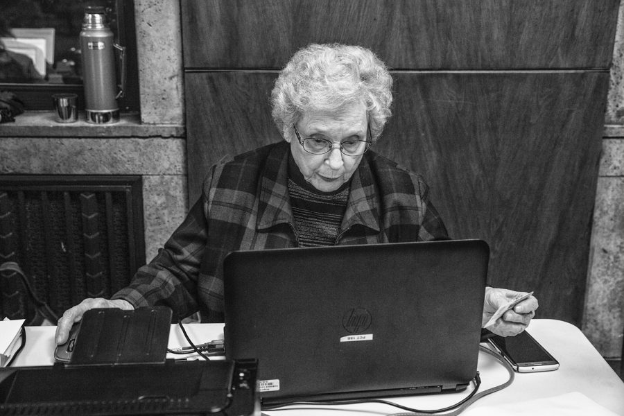 Damaris Eichman of Dubuque signs in a voter at a polling location in the Historic Dubuque Federal Building in Dubuque on Tuesday Nov. 6, 2018. Eichman, 87, says she has worked at polling places during every election for at least 40 years.