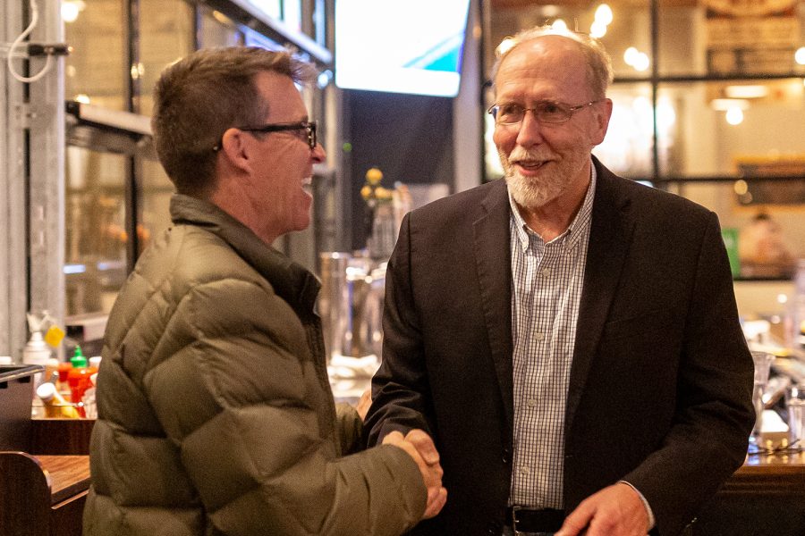 Congressman Dave Loebsack (D-IA) (center) shakes hands with Iowa State Senator Joe Bolkcom at an election night watch party at Big Grove Brewery in Iowa City on Tuesday, Nov. 6, 2018. (David Harmantas/The Daily Iowan)