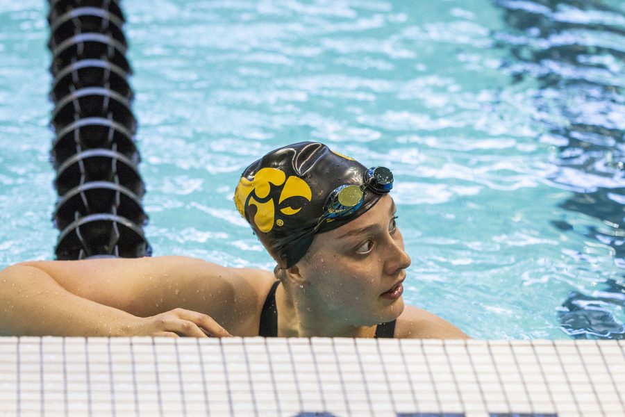 Iowa swimmer Hannah Burvill rests after finishing her race during the Hawkeye Invitational swim meet at the Campus Recreation and Wellness Center on Thursday Nov. 15, 2018. Iowa competed against 14 schools across the midwest in a variety of events including free relay, freestyle, and medley relay.