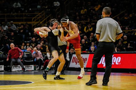 Iowas Myles Wilson wrestles Iowa States Marcus Coleman during Iowas dual meet against Iowa State at Carver-Hawkeye Arena in Iowa City on Saturday, December 1, 2018. Wilson lost to Coleman after an injury default. Iowa defeated the Cyclones 19-18. (Wyatt Dlouhy/The Daily Iowan)