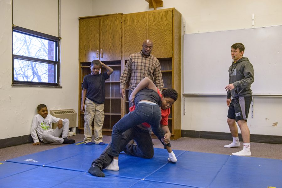 Fifth Ward Saints founder Carlos Honore works with students and volunteer coaches during a wrestling practice at Theodore Roosevelt Education Center on Monday, December 10, 2018. Fifth Ward Saints provides social-services alongside a variety of athletic and activity based after school programs to at risk students.
