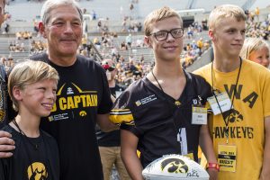 Kid Captain Gabe Graber takes a photo with his family and Iowa head coach Kirk Ferentz during Iowa Football Kids Day at Kinnick Stadium on Saturday, August 11, 2018. The 2018 Kid Captains met the Iowa football team and participated in a behind-the-scenes tour of Kinnick Stadium. Gwens story will be featured during Iowas first home game on Saturday. (Katina Zentz/The Daily Iowan)
