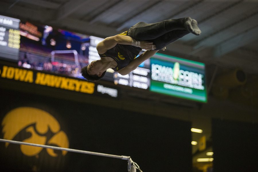 Bennet Huang performs on the horizontal bar during mens gymnastics Iowa vs. Penn State and Arizona State on Mar. 3, 2018 at Carver Hawkeye Arena. 