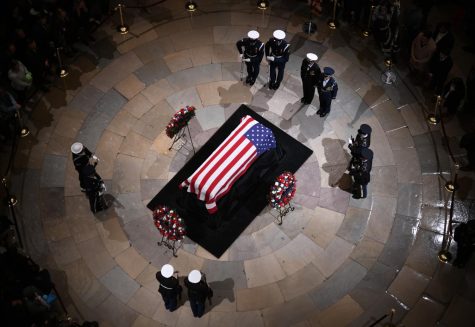 Joint services military honor guards stand next to the flag-draped casket of former U.S. President George H.W. Bush on the Lincoln catafalque during a memorial service at the Capitol Rotunda on Dec. 3, 2018 in Washington, D.C. (Olivier Douliery/Abaca Press/TNS)