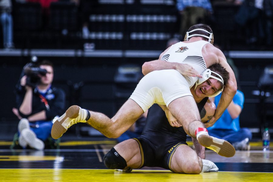 Iowa's Cash Wilcke wrestle's Lehigh's Andrew Price during a wrestling dual-meet between Iowa and Lehigh at Carver-Hawkeye Arena on Saturday, Dec. 8, 2018. Wilcke, who is ranked fourteenth at 184, defeated Price 6-4, and the Hawkeyes defeated the Mountain Hawks, 28-14. 