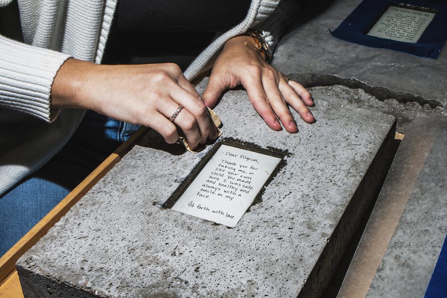 UI intermedia graduate student Melissa Airy sands down a stone, part of her series "Dear Pilgrim, Thank You," in the Visual Arts Building on Friday, November 16, 2018. Airy dedicates her artwork to show how the Camino de Santiago, a 500-mile pilgrimage across Spain, impacted her life personally and as an artist. 