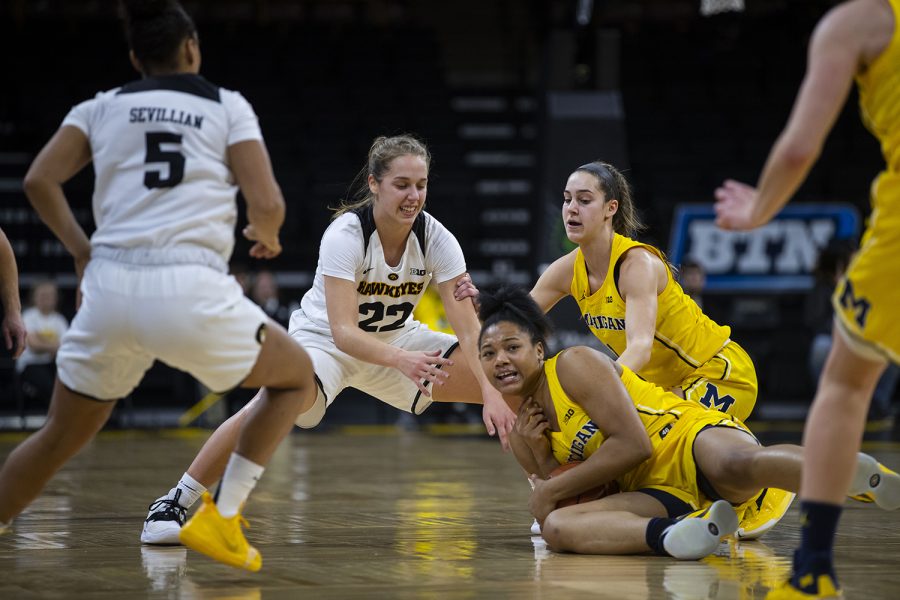 Iowa guard Kathleen Doyle attempts to strip the ball from Michigan forward Naz Hillmon during the Iowa/Michigan womens basketball game at Carver-Hawkeye Arena on Thursday, January 17, 2019. The Hawkeyes defeated the Wolverines, 75-61.