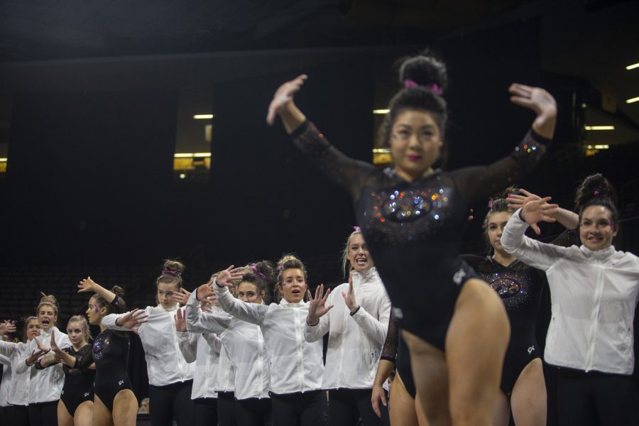 Hawkeyes cheer on their teammate Clair Kaji during the womens gymnastic meet against the University of Minnesota on Saturday, January 19, 2019. The Gophers defeated the Hawkeyes 195.475- 194.350. Kaji got a 9.775 for her floor exercise. 