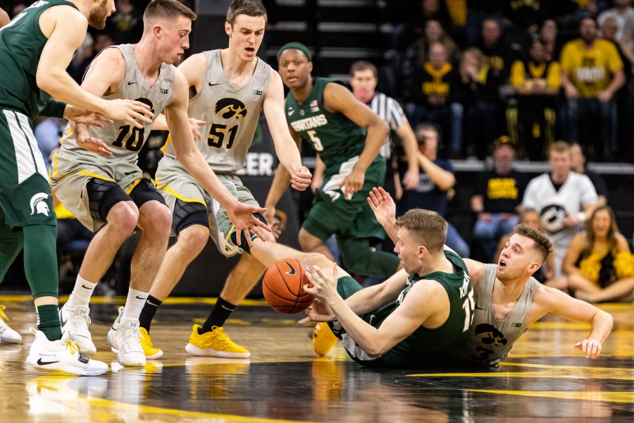 Players battle for the ball during a basketball game between Iowa and Michigan State at Carver-Hawkeye Arena on Thursday, Jan. 24, 2019. At halftime, the Hawkeyes led the Spartans 35-31. 