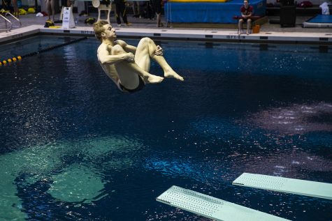 Iowa diver Will Brenner flips in the air during the Northwestern/Wisconsin swim meet at the Campus Recreation and Wellness Center on Saturday, January 19, 2019. The mens swimming and diving team defeated the Badgers, 164-136, and the Wildcats, 194-106. The womens swimming and diving team fell to the Badgers, 191-109, and the Wildcats, 178-122. 