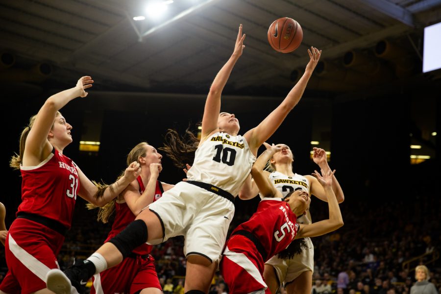 Iowa forward Hannah Stewart #21 rebounds a ball late in the fourth quarter in a women's basketball game against the Nebraska Huskers at Carver-Hawkeye Arena on Thursaday January 3, 2018. The Hawkeyes beat the Huskers, 77-71.