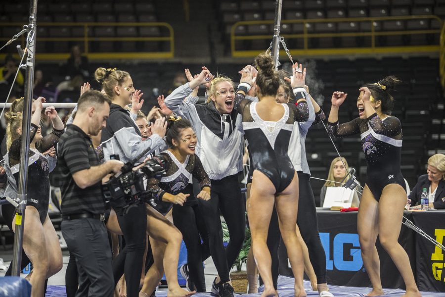 The Iowa womens gymnastics team celebrates together during a meet against Rutgers on Saturday, January 26, 2019. The Hawkeyes defeated the Scarlet Knights 194.575 to 191.675. 