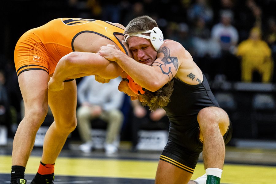 Iowas #12 ranked Cash Wilcke grapples with Princetons Kevin Parker in a 184-lb wrestling match at Carver-Hawkeye Arena on Friday, Nov. 16, 2018. Wilcke defeated Parker 8-2. 