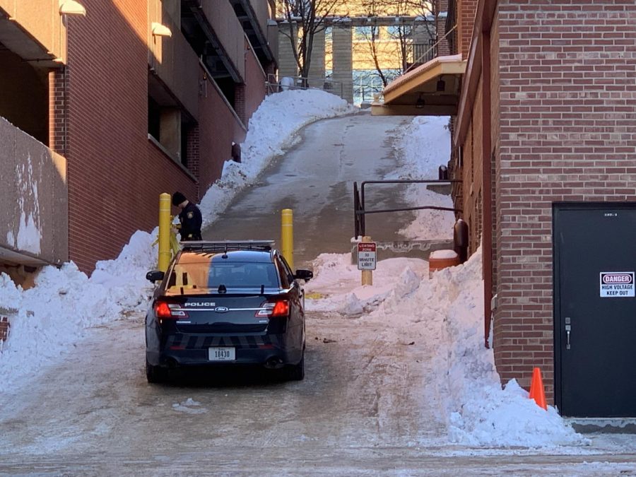 Police take down caution tape in the alleyway behind Halsey Hall on the UI campus, where Gerald Belz was found unresponsive early Wednesday morning. 
