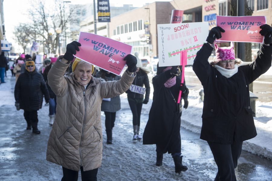 Attendees march on the pedestrian mall for the annual Womens March in Iowa City on Saturday, January 19, 2019. The Womens March is an annual event that started in 2017 following the inauguration of President Donald Trump. The march advocates for a range of issues including womens rights,  healthcare reform, LGBTQ+ rights, and environmental issues. 