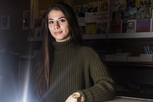 UI senior Ava Gripp poses for a portrait in Prairie Lights on Monday, January 14, 2019. Gripp serves as the editor of Ache Magazine, a collection of art and writing focused on the concept of ache and nostalgia. 