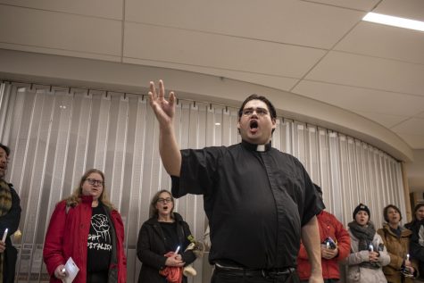 Father Guillermo Trevino addresses the bench vigil attendees Tuesday night at Iowa City City Hall on Tuesday, Jan. 22, 2019. 