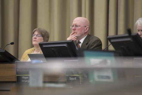 Iowa City Mayor Jim Throgmorton listens as community members address complaints regarding the new benches for the Pedestrian Mall at City Hall in Iowa City on Tuesday, January 22, 2019. Some community members feel that the new benches are hostile to the homeless.