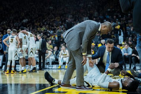 Trainers tend to Iowa forward Tyler Cook during a mens basketball matchup between Ohio State and Iowa at Carver-Hawkeye Arena on Saturday, January 12, 2019. The Hawkeyes defeated the Buckeyes, 72-62. 