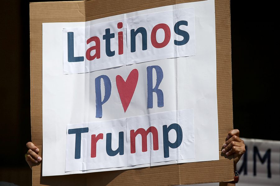 A+man+hoists+a+sign+during+a+rally+of+about+100+of+Donald+Trump%26apos%3Bs+Latino+supporters+outside+Anaheim+City+Hall+on+Aug.+28%2C+2016.+%28Luis+Sinco%2FLos+Angeles+Times%2FTNS%29