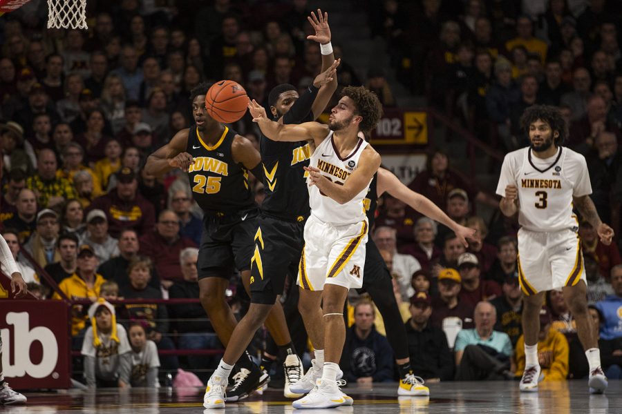 Iowa guard Isaiah Moss (4) defends against Minnesota guard Gabe Kalscheur (22) during mens basketball vs. Minnesota at Williams Arena on Sunday, January 27, 2019. The Gophers defeated the Hawkeyes 92-87.