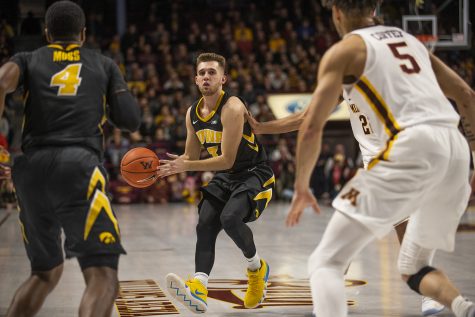 Iowa guard Jordan Bohannon readies a pass against Minnesota at Williams Arena on Sunday. The Gophers defeated the Hawkeyes, 92-87. 