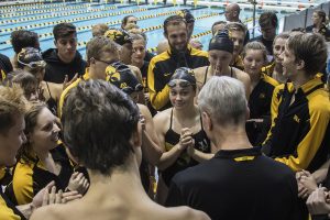 The Iowa swim team huddles during a swim meet where Iowa hosted the University of Denver and University of Michigan at the Campus Recreation and Wellness Center on Saturday, November 3, 2018. 