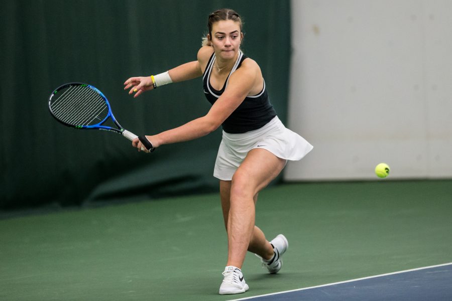 Iowas Sophie Clark chips a backhand during a womens tennis match between Iowa and Northern Texas on Sunday, January 20, 2019. The Hawkeyes defeated the Mean Green, 5-2.
