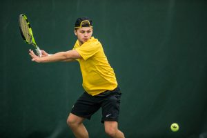 Iowas Will Davies hits a forehand during a mens tennis matchup between Iowa and Butler on Sunday, January 27, 2019. The Hawkeyes defeated the Bulldogs, 5-2.