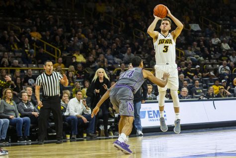 Iowa guard Jordan Bohannon attempts a 3-pointer during the Iowa/Northwestern mens basketball game at Carver-Hawkeye Arena on Sunday, February 10, 2019. 