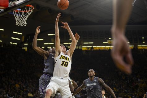 Iowa guard Joe Wieskamp to grab a rebound during the Iowa/Northwestern mens basketball game at Carver-Hawkeye Arena on Sunday, February 10, 2019. The Hawkeyes defeated the Wildcats, 80-79. 
