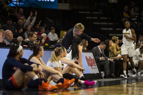 Iowa head coach Lisa Bluder (top center) gestures in conversation with center Megan Gustafson (bottom center) during the Iowa/Illinois womens basketball game at Carver-Hawkeye Arena on Thursday, February 14, 2019. The Hawkeyes defeated the Fighting Illini, 88-66.