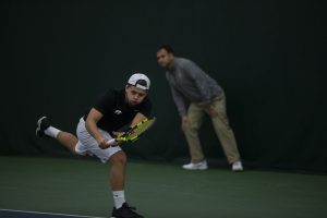 Will Davies dives to save the ball during men's tennis against the University of Nebraska Omaha at the Hawkeye Tennis and Recreation Complex on Feb. 15, 2019. The hawkeyes defeated Omaha 5-2. Davies and his double's partner Oliver Okonkwo lost their match. 