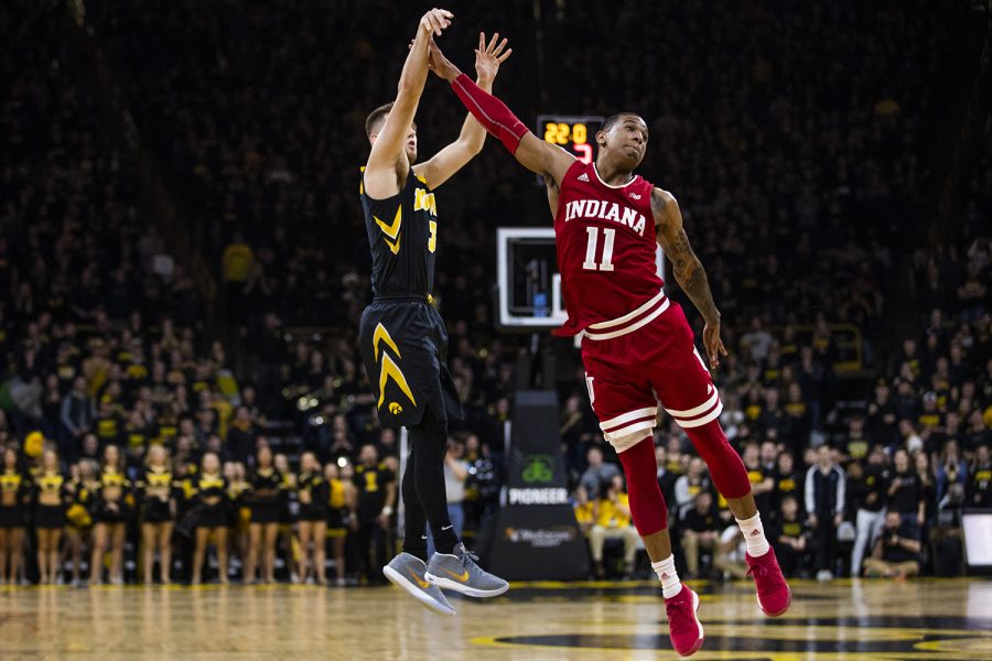 Iowa guard Jordan Bohannon shoots the ball past Indiana guard Devonte Green during men's basketball vs. Indiana at Carver-Hawkeye Arena on Friday, February 22, 2019. The Hawkeyes defeated the Hoosiers 76-70. (Katina Zentz/The Daily Iowan)