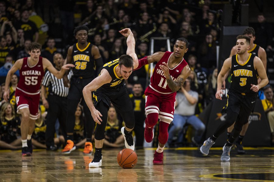 Indiana guard Devonte Green and Iowa guard Connor McCaffery run for the ball during the men's basketball game vs. Indiana at Carver-Hawkeye Arena on Friday, February 22, 2019. The Hawkeyes defeated the Hoosiers 76-70. 