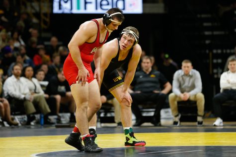 Iowa Wrestler #5 Jacob Warner grapples with Maryland Wrestler Niko Cappello in the 197lb weight class during a wrestling dual meet at Carver-Hawkeye Arena on Friday, Feb. 8, 2019. Warner won via tech fall 24-9 and the Hawkeyes defeated the Terrapins 48-0. 