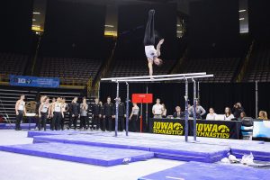 Iowa gymnast Rogelio Vazquez performs on the parallel bars during a gymnastics meet against Minnesota and Illinois-Chicago on Saturday, Feb 2, 2019. The Golden Gophers won the meet with a total score of 406.400 with the Hawkeyes scoring 401.600 and the Flames scoring 355.750. 
