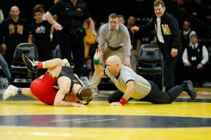 The referee slaps the mat and signals the pin for Iowa Wrestler #2 Spencer Lee in the 125lb weight match Brandon Clay during a wrestling dual meet at Carver-Hawkeye Arena on Friday, Feb. 8, 2019. Lee won via pin at 00:30 and the Hawkeyes defeated the Terrapins 48-0. 