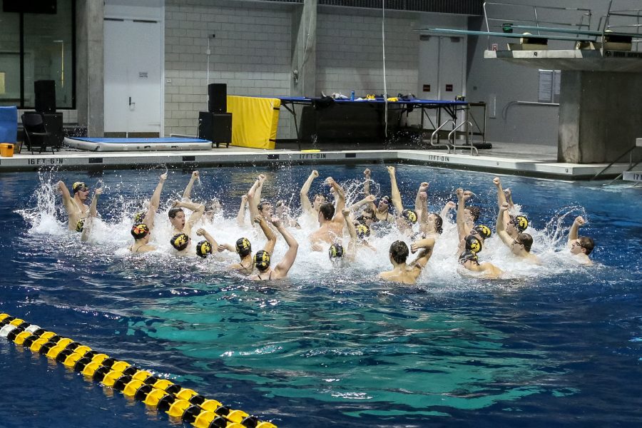The Iowa swimming and diving teams sing the Iowa fight song after a swim meet against the University of Northern Iowa and Western Illinois University on Friday, Feb. 1. 