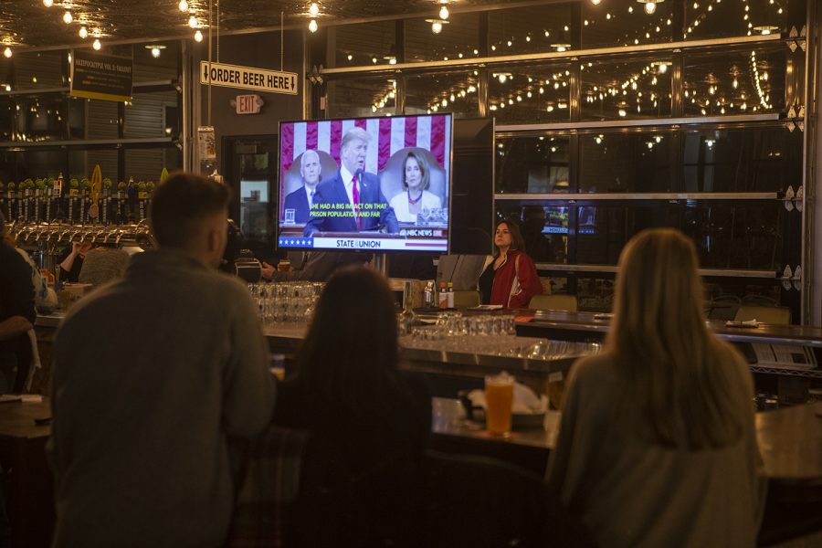 The TV behind the bar at Big Grove shows the State of the Union Speech at the Johnson County Democratic viewing party for the State of the Union held in Big Grove Brewery on Tuesday, Feb 5, 2019 