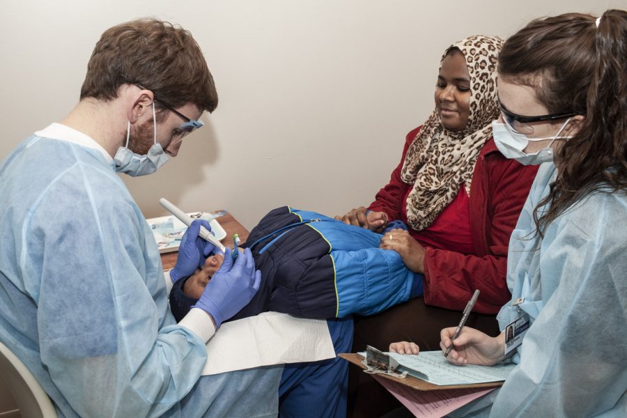 Pediatric dentistry specialist Dr. Kyle Nordeen performs an examination on 2-year old Ahmed Osman as Ahmed's mother Hagir Malik and fourth-year UI dental student Elise Montesinos watch on Thursday, Feb. 21, 2019 at a clinic in the Johnson County Health and Human Services Building. The Free Dental Clinic has served more than 3,700 children ages 3 and under in its more than 20 years of existence.