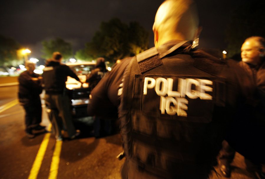 U.S. Immigration and Customs Enforcement ICE agents plan an early morning action on Monday March 26, 2012 at the Los Angeles Sheriff Station parking lot in Valencia, Calif. 