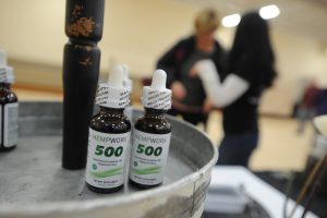 Teressa Sworsky talks with potential customers and explains the benefits of hemp oil and other CBD products at the Mokena Park District's January Flea Market on Jan. 13, 2019 in Mokena, Ill.  (Warren Skalski/Chicago Tribune/TNS)