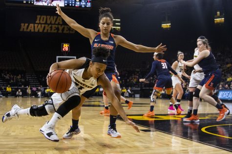 Iowa guard Tania Davis falls while dribbling to the basket during the Iowa/Illinois womens basketball game at Carver-Hawkeye Arena on Thursday, February 14, 2019. The Hawkeyes defeated the Fighting Illini, 88-66. 