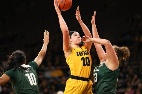 Iowa forward Megan Gustafson (10) fights for a layup during a basketball game against Michigan State on Thursday, Feb. 7, 2019. The Hawkeyes defeated the Spartans 86-71. Gustafson led all scorers with 41 points.