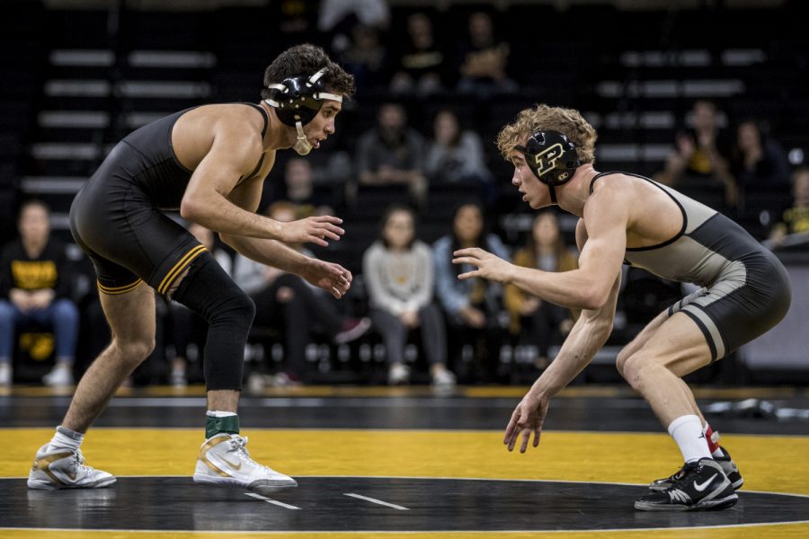 Iowas Perez Perez and Purdues Devin Schroder wrestle during Iowas dual meet against Purdue at Carver-Hawkeye Arena in Iowa City on Saturday, November 24, 2018. Schroder defeated Perez by 4-2. The Hawkeyes defeated the Boilermakers 26-9.