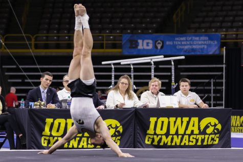 Judges watch Iowa gymnast Bennet Huang perform on the floor during a gymnastics meet against Minnesota and Illinois-Chicago on Saturday, Feb 2, 2019. The Golden Gophers won the meet with a total score of 406.400 with the Hawkeyes scoring 401.600 and the Flames scoring 355.750. 